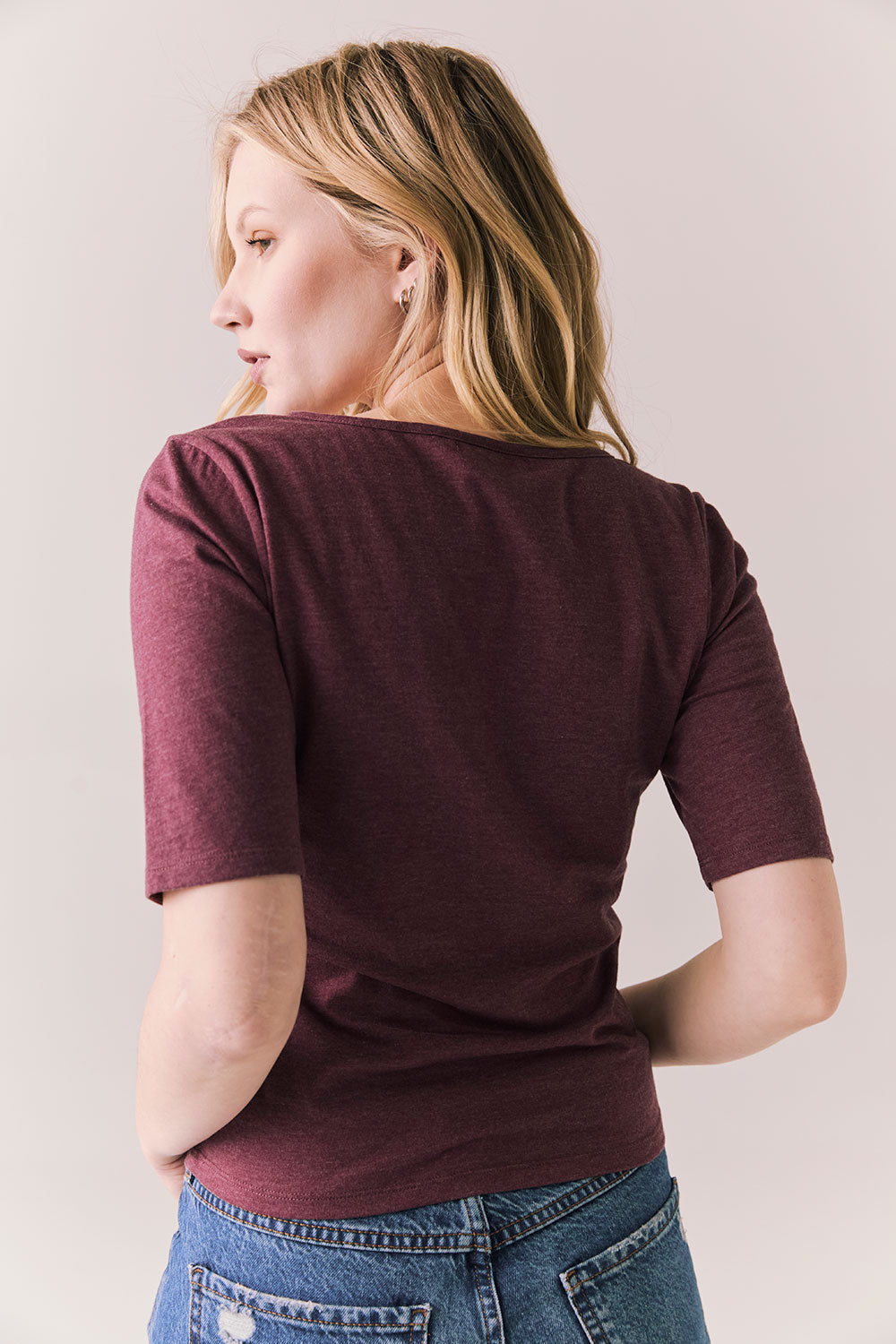 Back view of Fresno tee in fig with scoop neck and fitted silhouette on a plain background