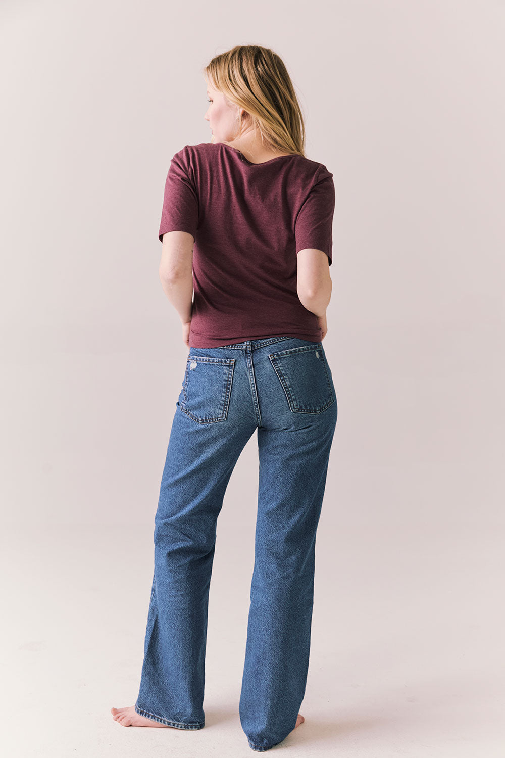 Full back view of Fresno tee in fig with scoop neck and fitted silhouette and denim on a plain background