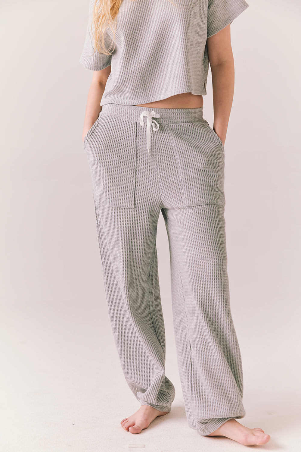 Front view of model wearing Billyy Joggers in heather grey