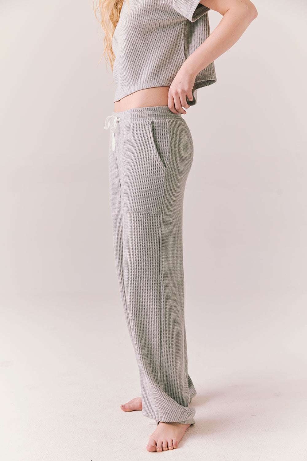 Side view of model wearing Billyy Joggers in heather grey