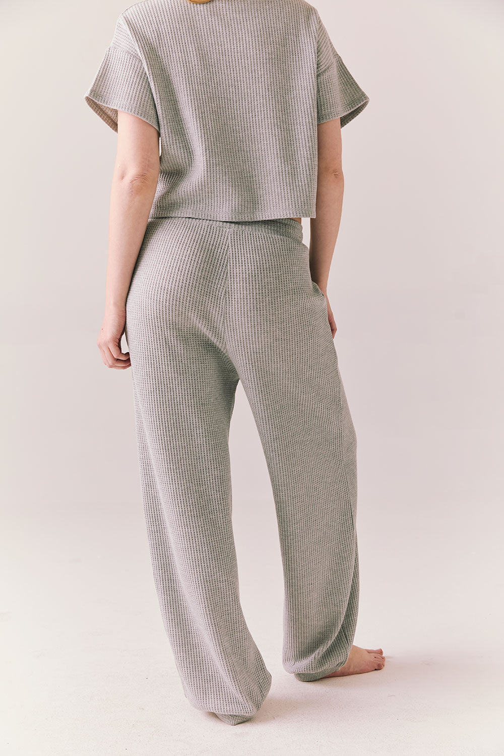 Back view of model wearing Billyy Joggers in heather grey