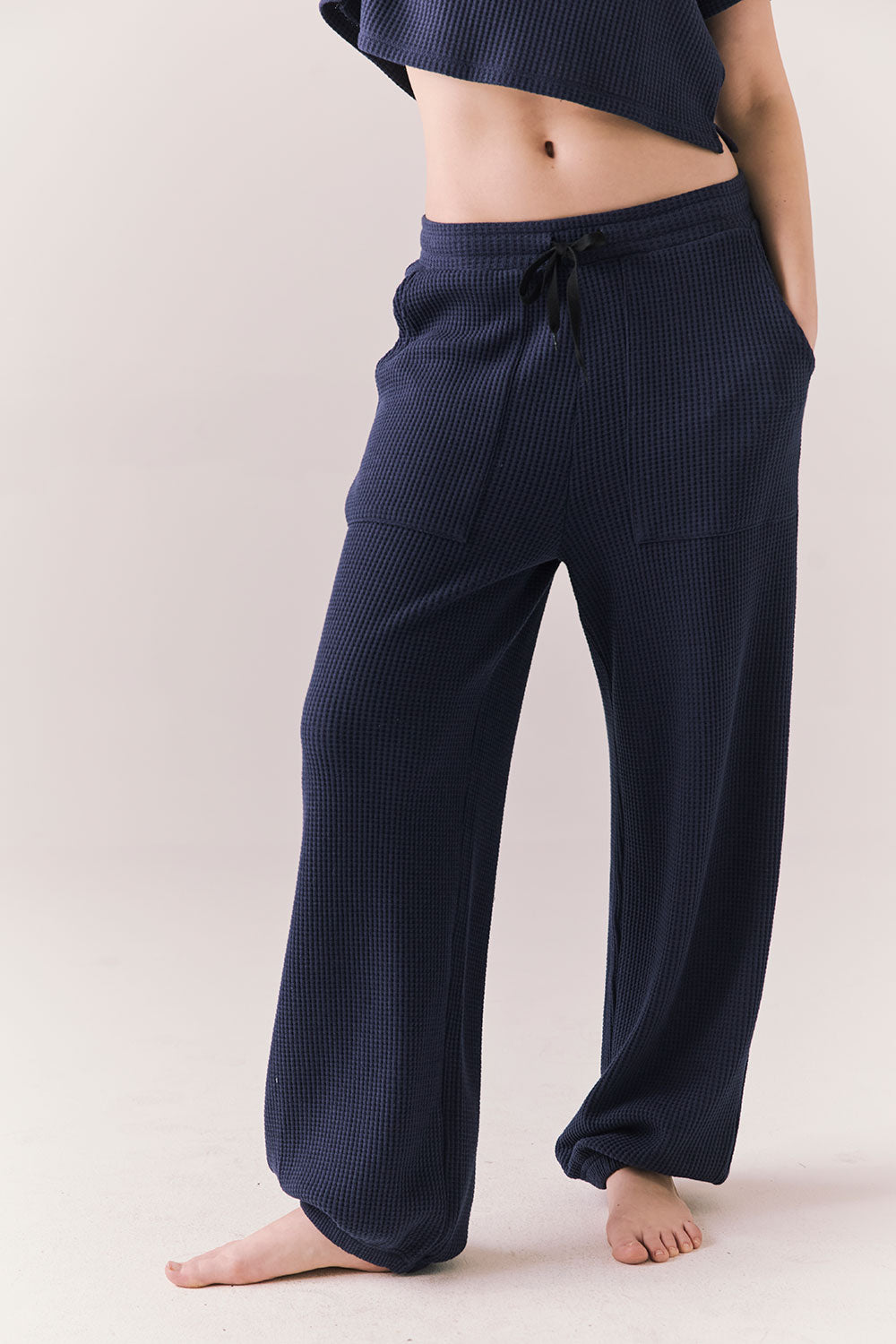 Front view of model wearing Billyy Joggers in midnight blue