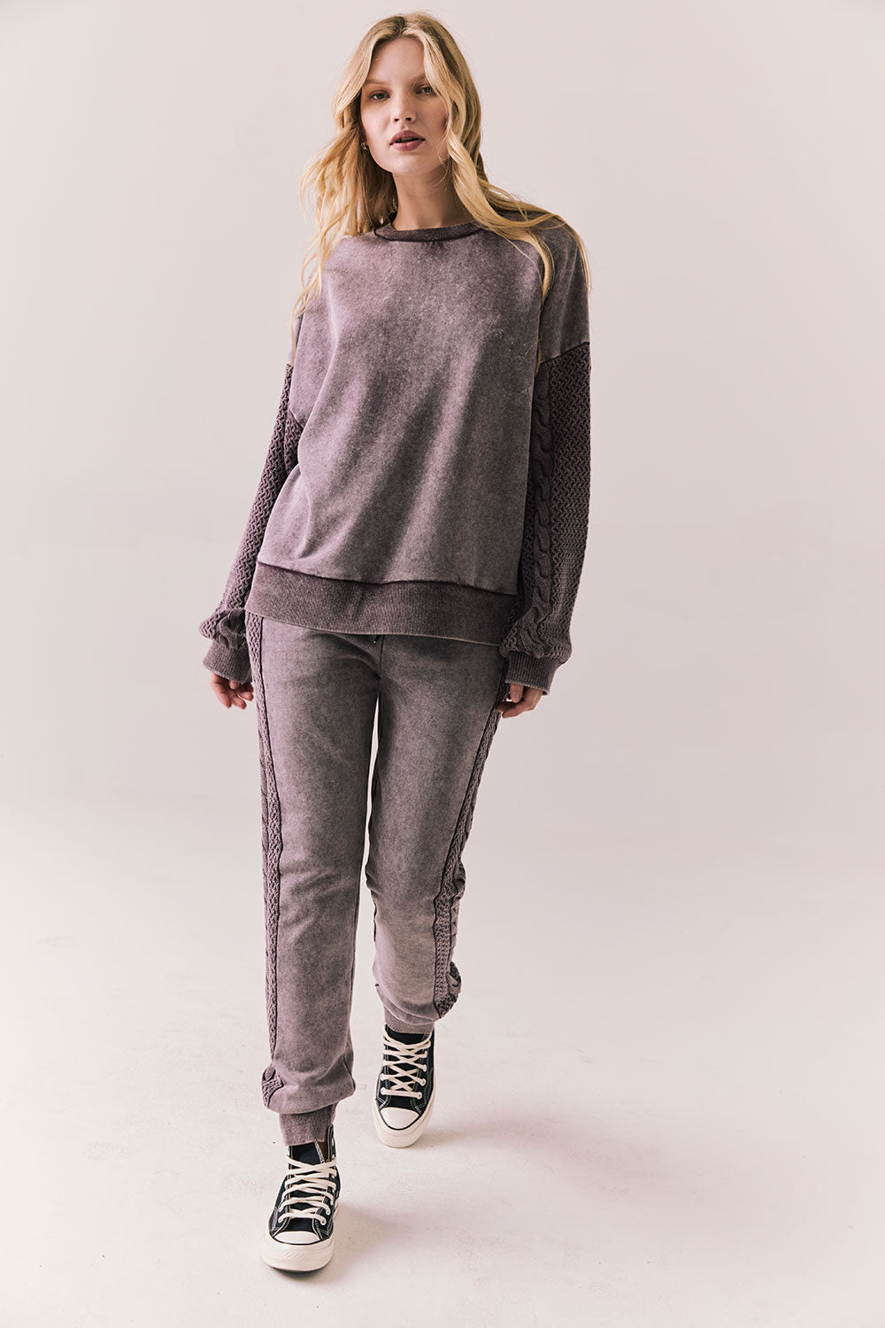 Full front view of Maritime Pullover in fig (deep purple) with relaxed fit and knit texture with matching Bay joggers against a plain background