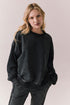Front view of Maritime Pullover in True Black with relaxed fit and knit texture against a plain background
