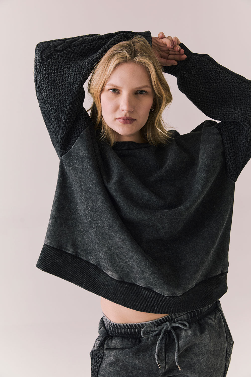 Front view of Maritime Pullover in True Black with relaxed fit and knit texture against a plain background