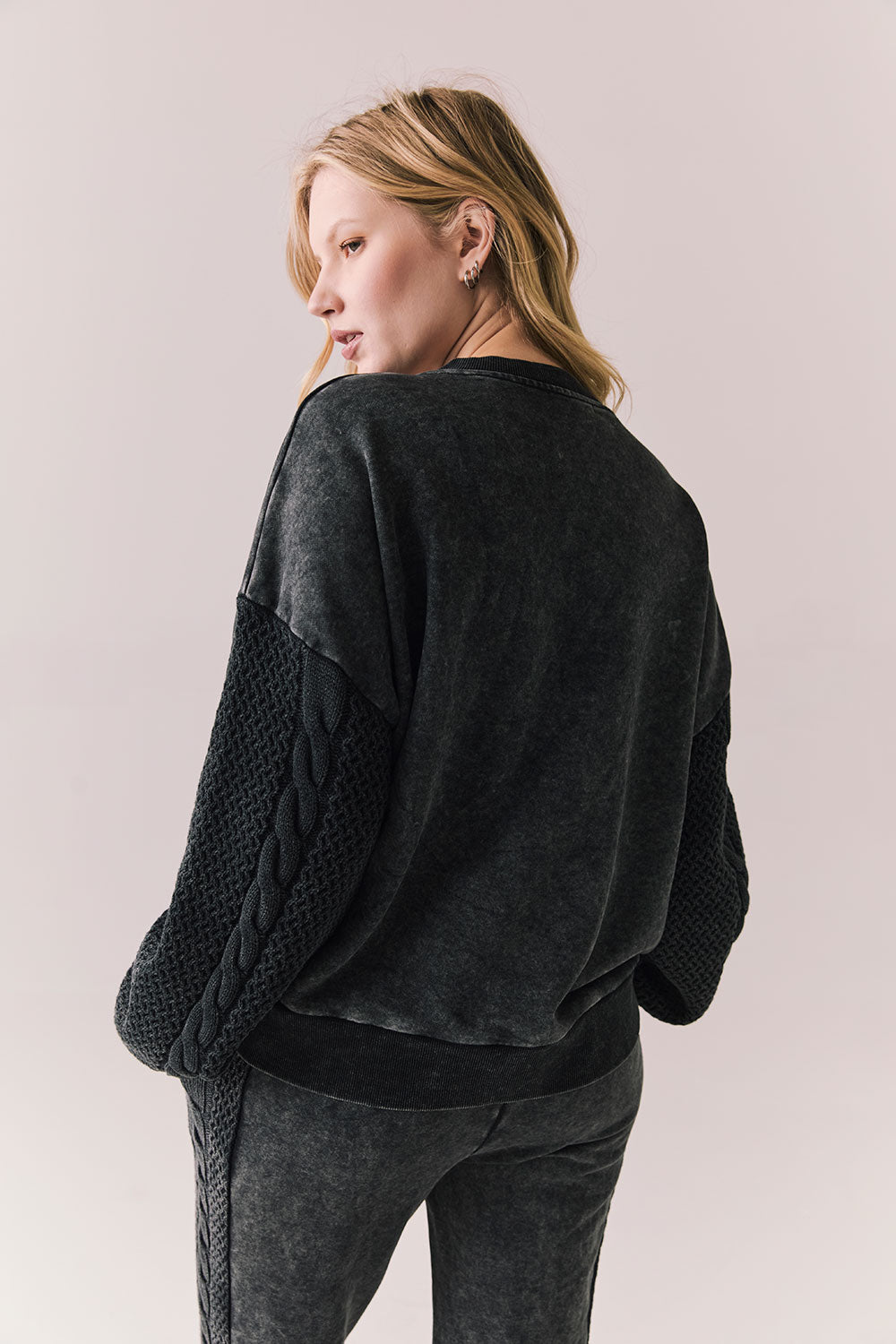 Back view of Maritime Pullover in True Black with relaxed fit and knit texture against a plain background