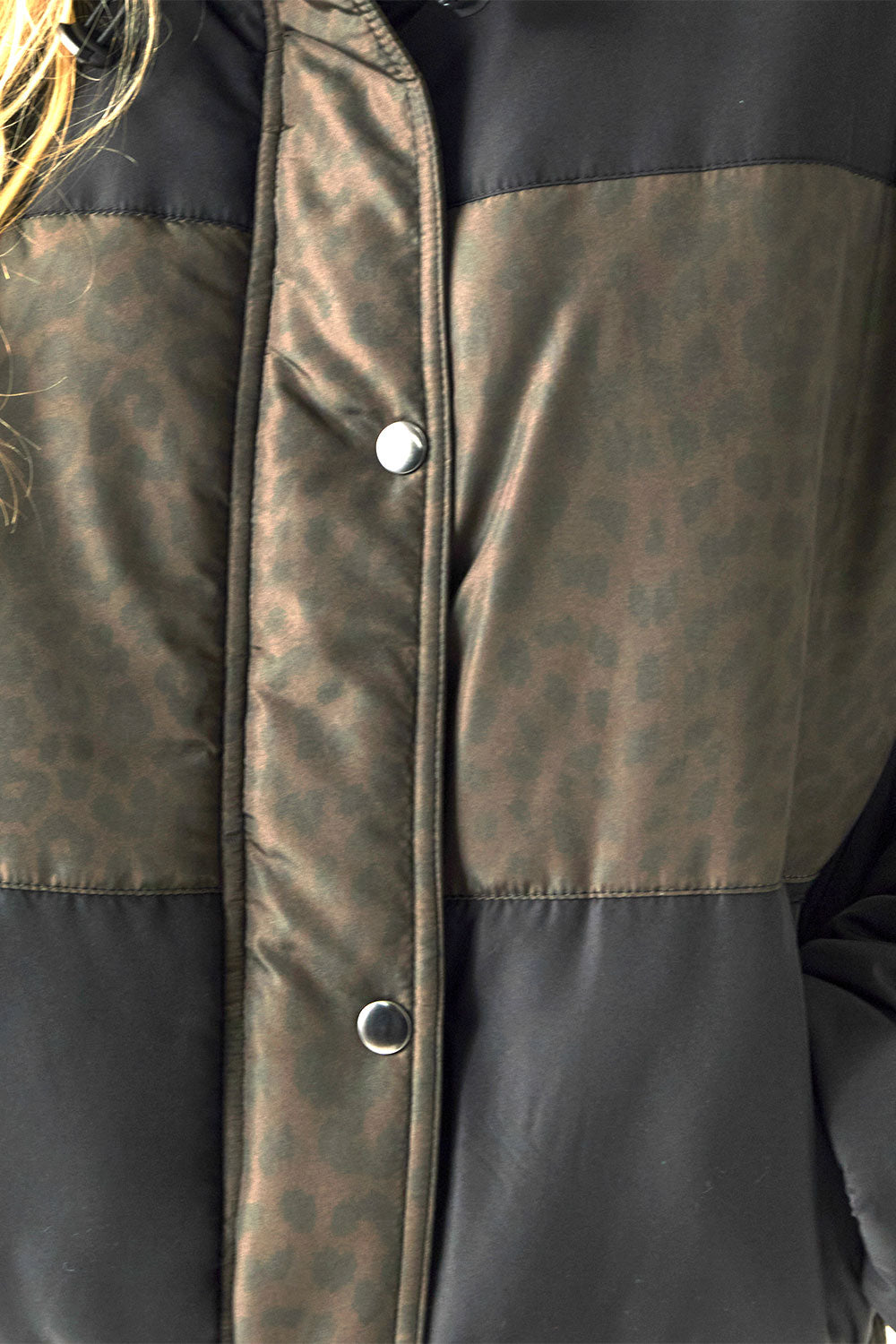 Closeup of Chasers Whistlerrr Leopard and True Black Puffer Close-up of Chaser Brand Whistler Leopard and True Black Puffer Jacket showing tonal leopard texture and snap-front detail
showing the leopard print