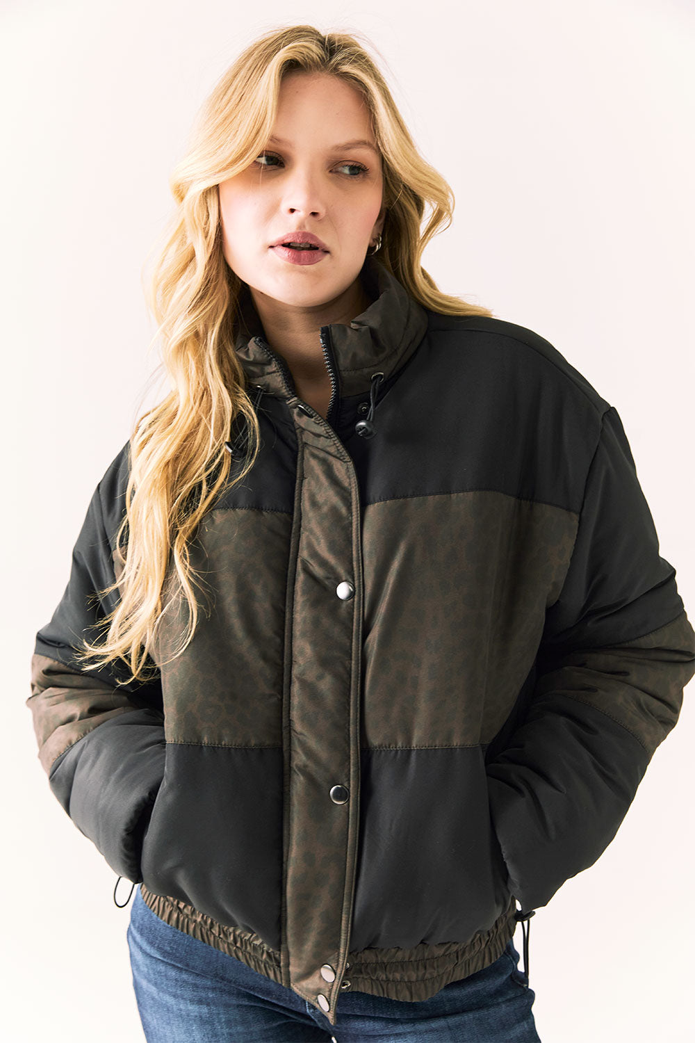 Front view of Chaser Brand Whistler Leopard and True Black Puffer Jacket featuring subtle leopard print and color-block design