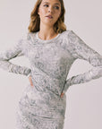Front view of woman wearing Chaser’s Ziggy Python Print Mini Dress with subtle snakeskin pattern on a white background