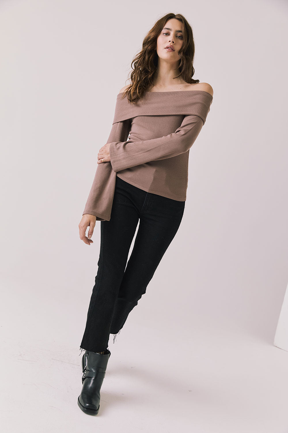 Full body view of woman wearing Chaser’s Pixie Deep Taupe Long Sleeve with black pants and boots on a white background