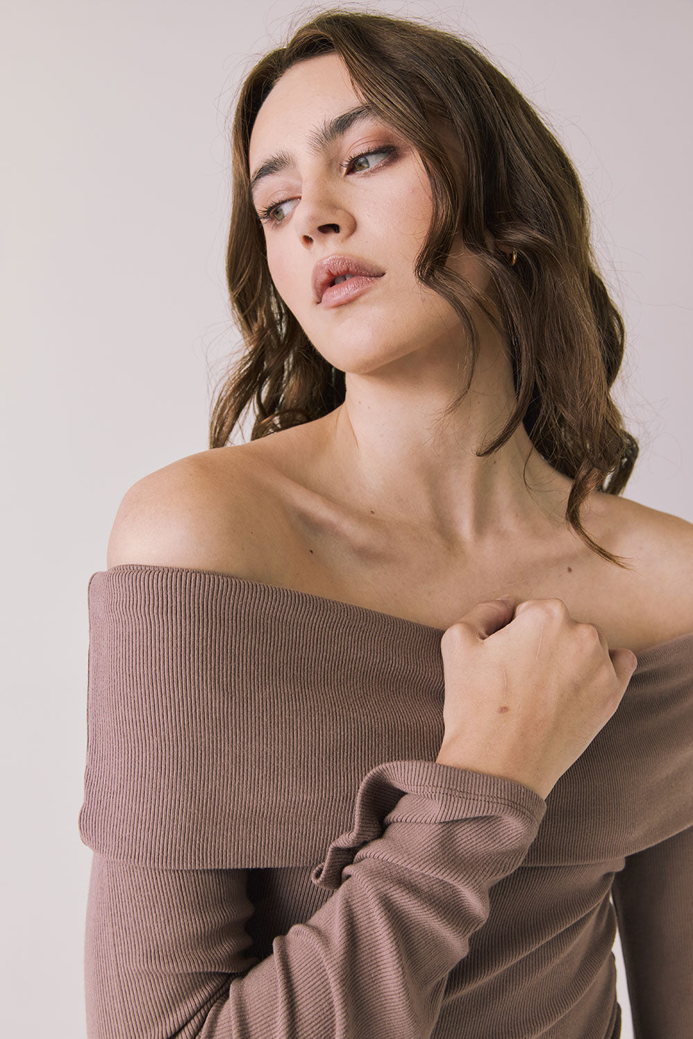 Front view of woman wearing Chaser’s Pixie Deep Taupe Long Sleeve with off-shoulder design on a white background