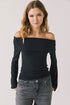 Front view of woman wearing Chaser’s Pixie True Black Long Sleeve with off-shoulder design on a white background