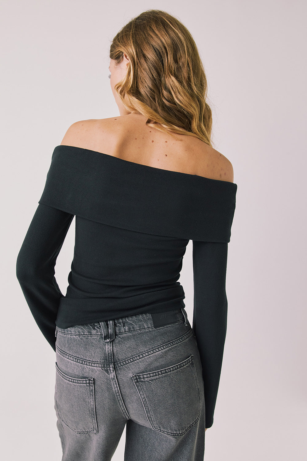 Back view of woman wearing Chaser’s Pixie True Black Long Sleeve on a white background