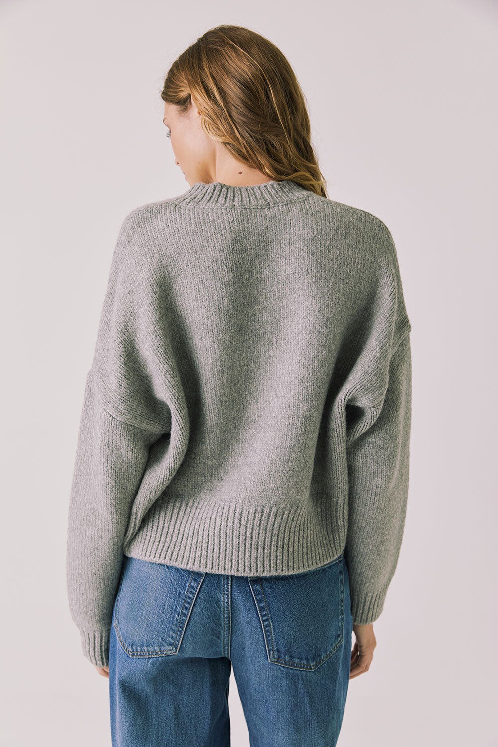 Back view of woman wearing Chaser’s Heather Grey Luck Zip Up Cardigan Sweater on a white background