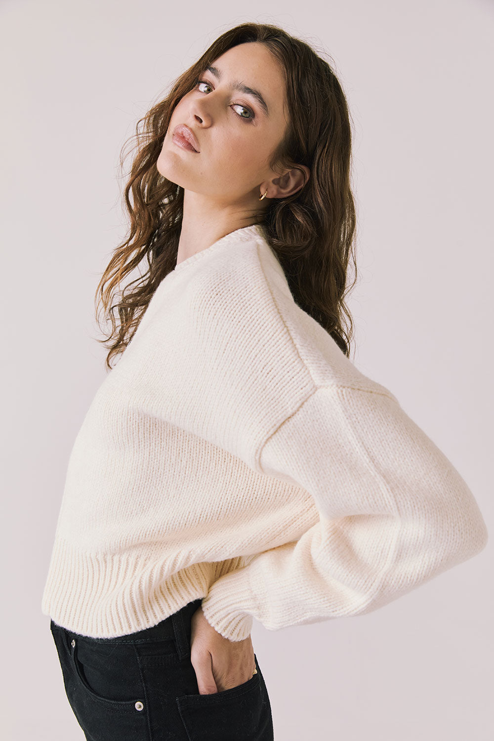 Side view of woman wearing Chaser’s Warm White Luck Zip Up Cardigan Sweater on a white background