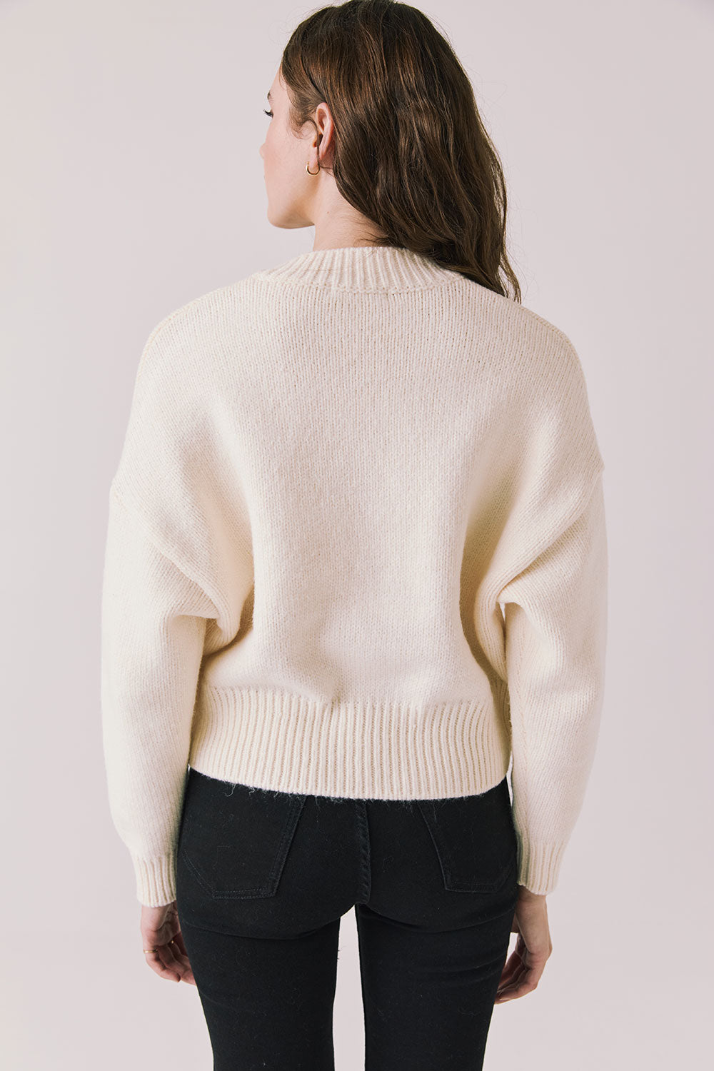 Back view of woman wearing Chaser’s Warm White Luck Zip Up Cardigan Sweater on a white background
