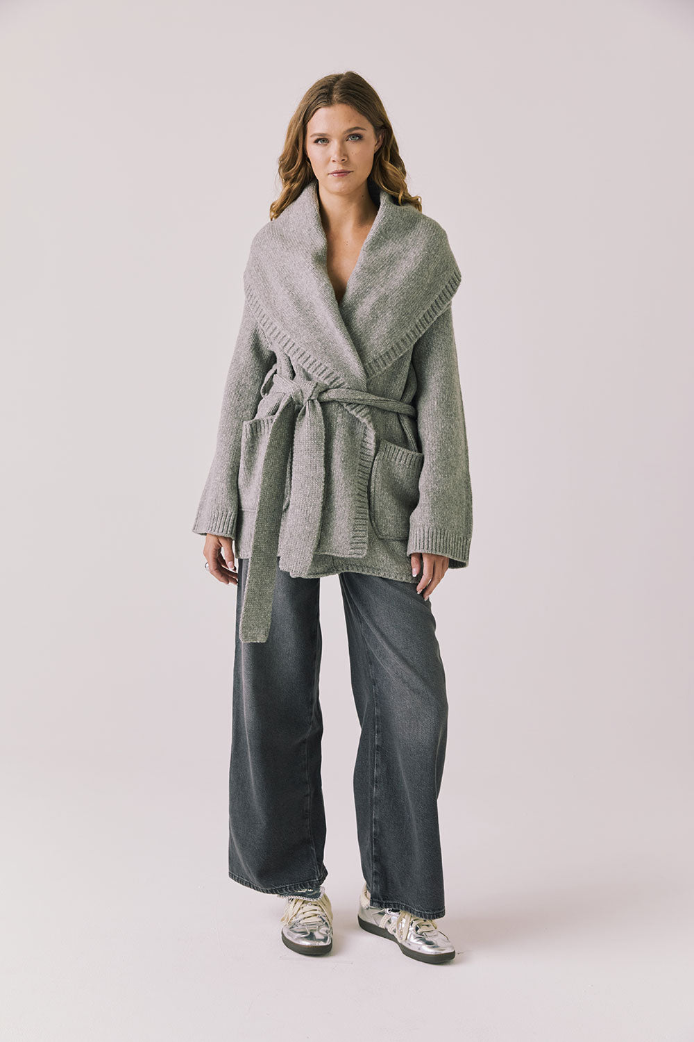 Full body view of woman wearing Chaser’s Eclipse Heather Grey Cardigan Robe styled with blue jeans on a white background