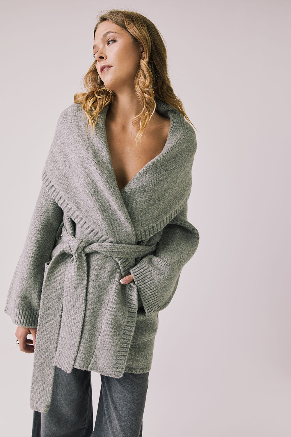 Front view of woman wearing Chaser’s Eclipse Heather Grey Cardigan Robe with blue jeans on a white background