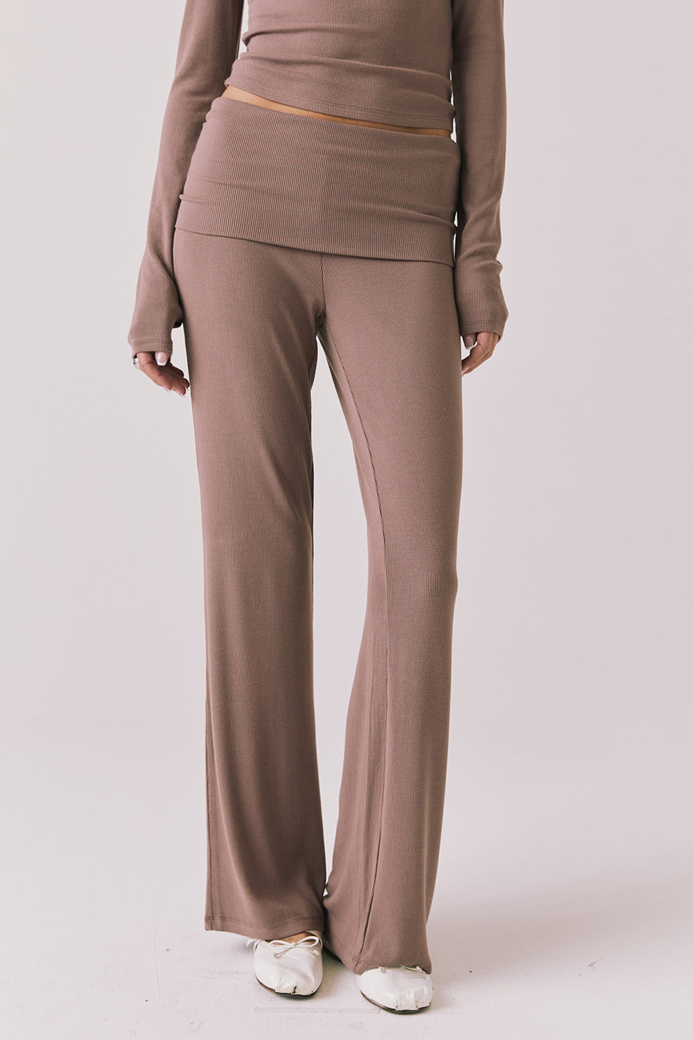 Front view of woman wearing Chaser’s Deep Taupe Mantra Legging on a plain background