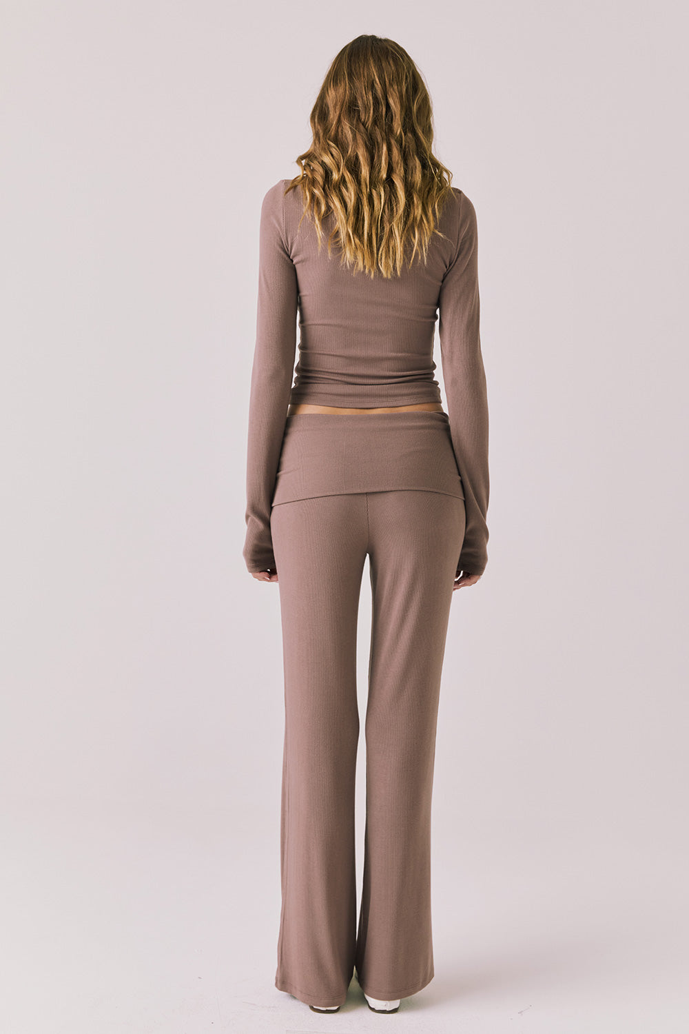 Full body back view of woman wearing Chaser’s Deep Taupe Mantra Legging with matching Porta Deep Taupe Long Sleeve on a plain background