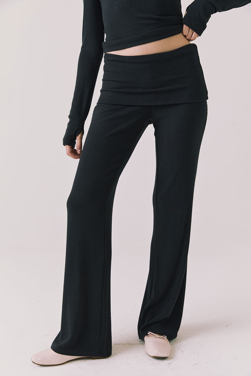 Front view of woman wearing Chaser’s True Black Mantra Legging on a plain background
