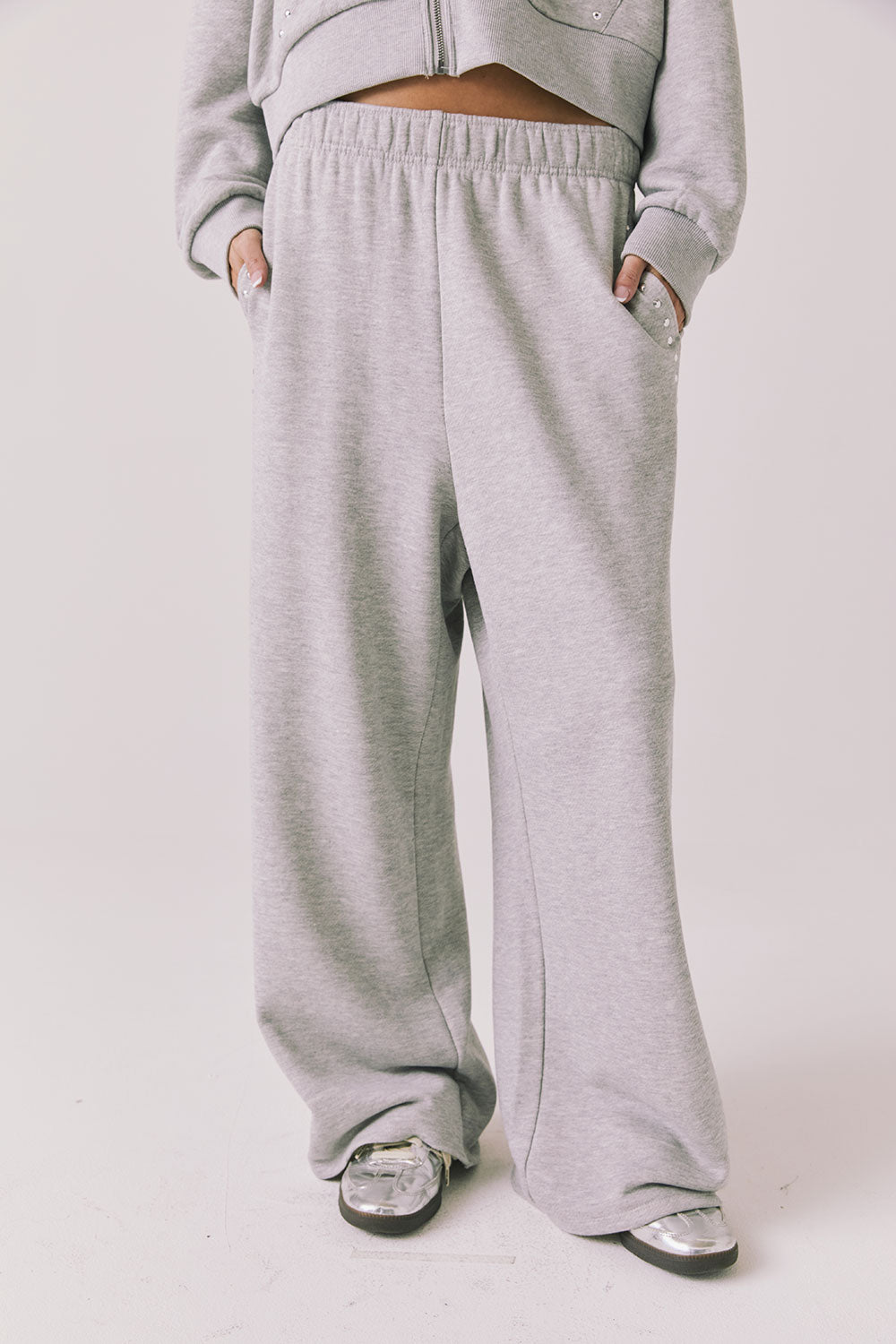 Front view of woman wearing Chaser’s Daze Heather Grey Joggers on a white background