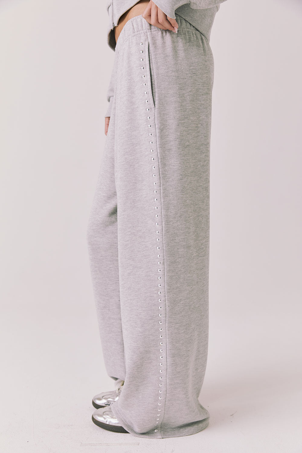 Side view of woman wearing Chaser’s Daze Heather Grey Joggers on a white background