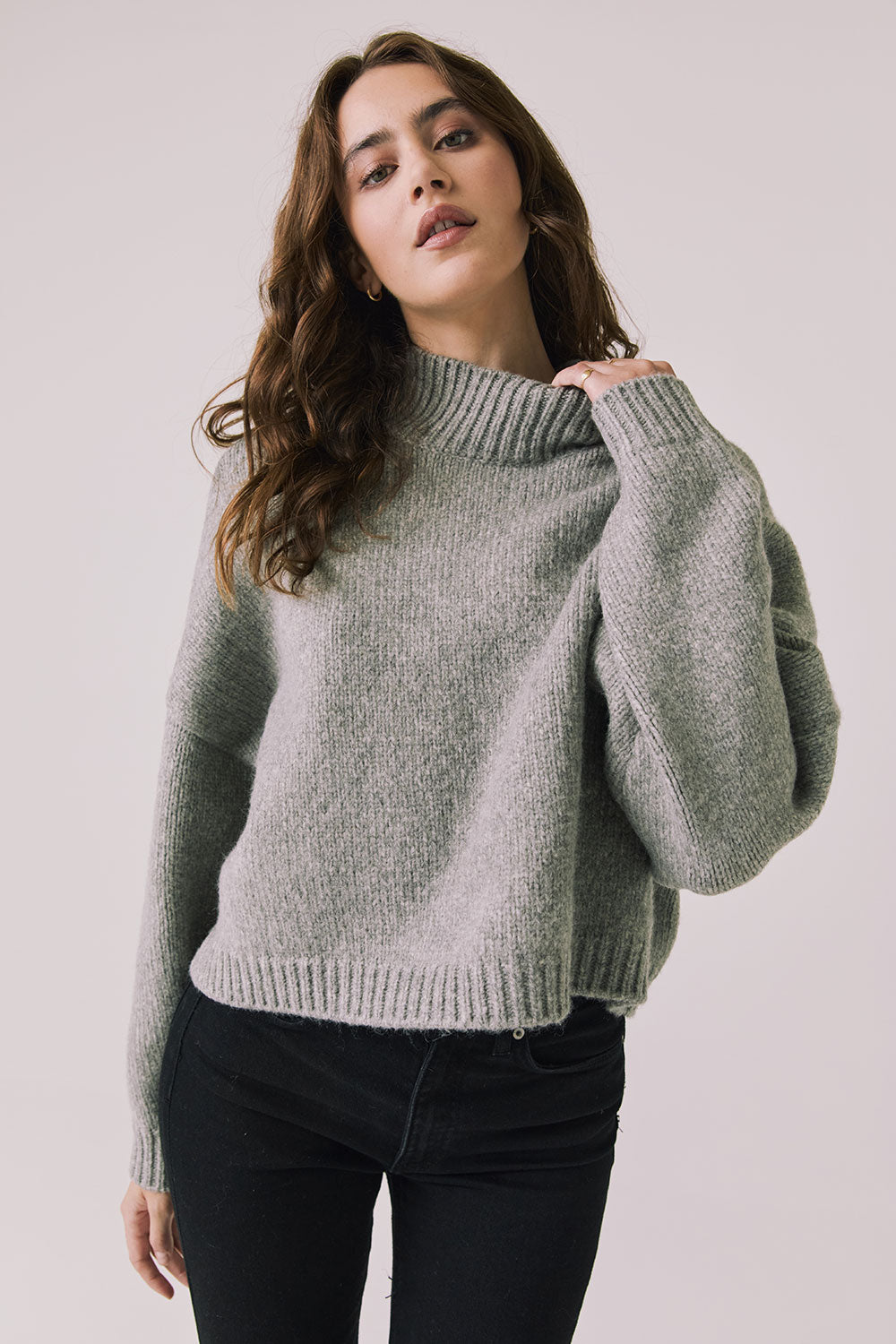 Front view of woman wearing Chaser’s Frankie Heather Grey Pullover Sweater with black pants on a white background