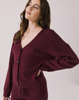 Side view of woman wearing Chaser’s Purple Fig Maison Cardigan Sweater on a white background