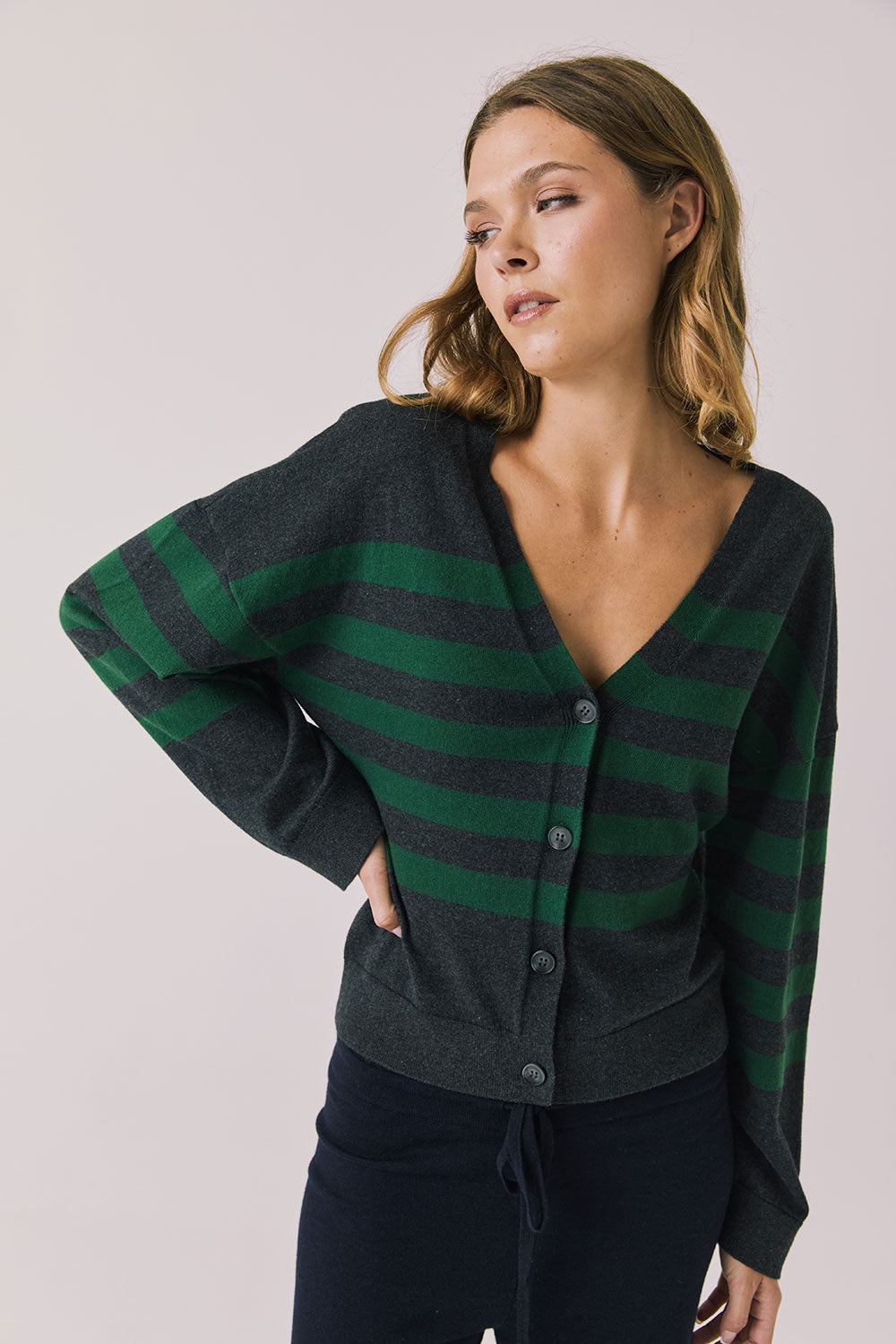 Front view of woman wearing Chaser’s Timeless Stripe Maison Cardigan Sweater on a white background