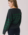 Back view of woman wearing Chaser’s Timeless Stripe Maison Cardigan Sweater on a white background