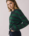Side view of woman wearing Chaser’s Boyfriend Timeless Stripe Pullover with green and blue striped pattern on a plain background.