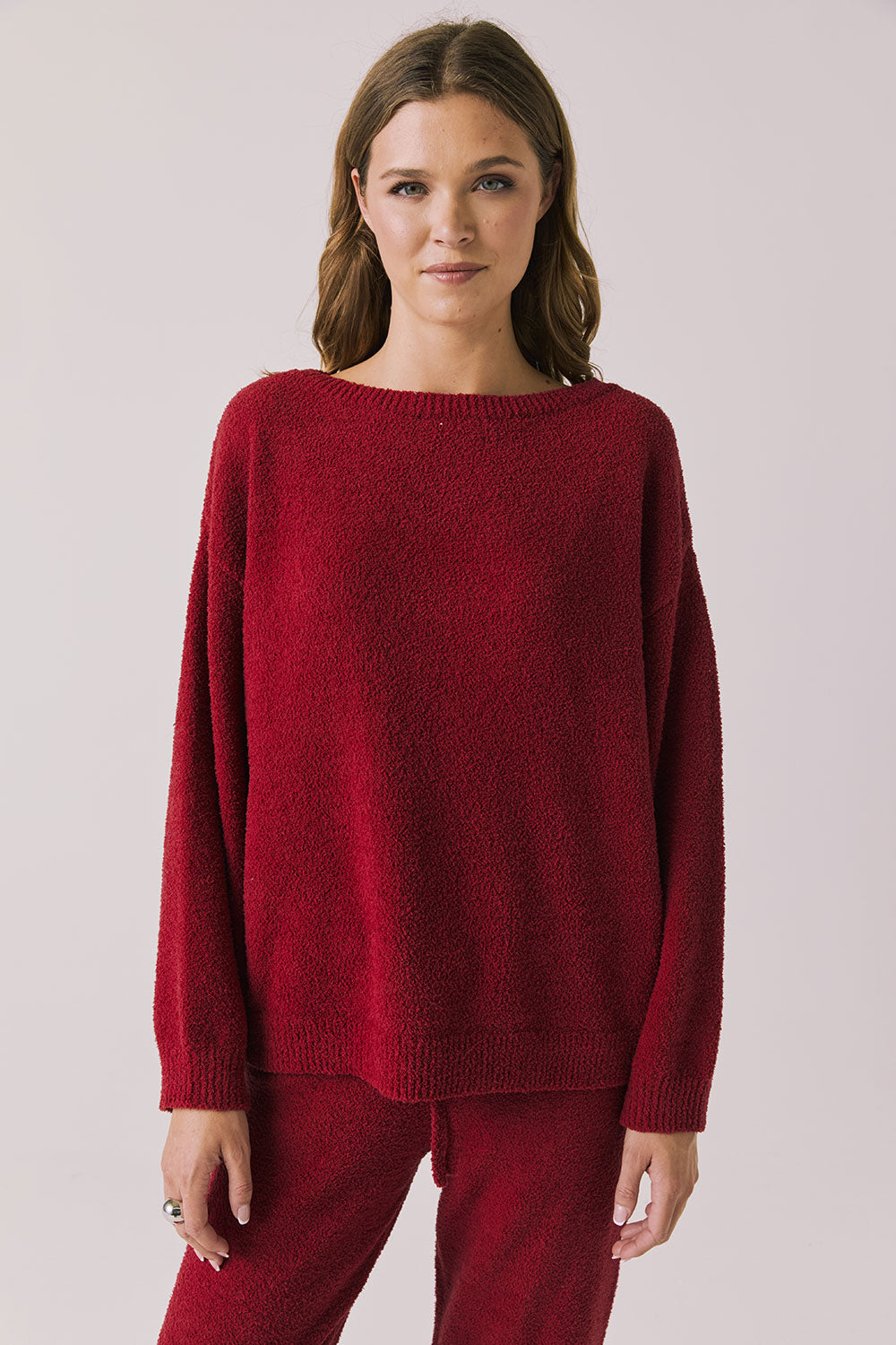 Front view of woman wearing Chaser’s Miller Purple-Red Fig Pullover Sweater on a white background