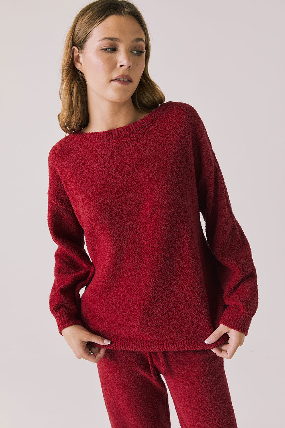 Front view of woman wearing Chaser’s Miller Purple-Red Fig Pullover Sweater on a white background