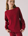 Front view of woman wearing Chaser’s Miller Purple-Red Fig Pullover Sweater on a white background