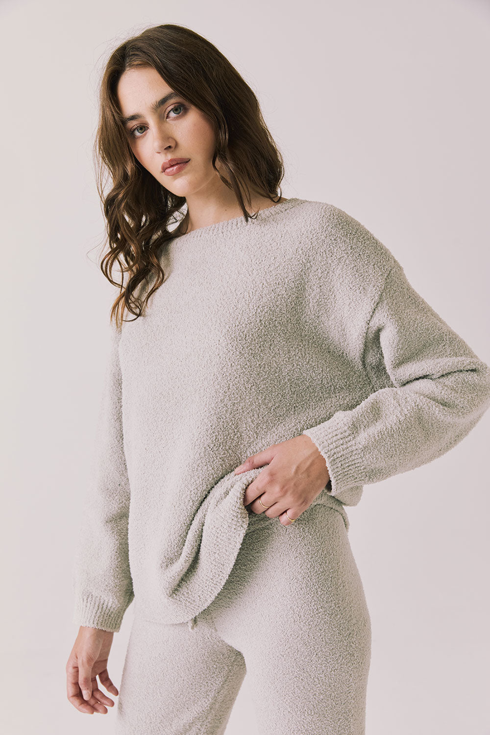 Side view of woman wearing Chaser’s Miller Heather Grey Pullover Sweater on a white background