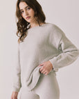 Side view of woman wearing Chaser’s Miller Heather Grey Pullover Sweater on a white background