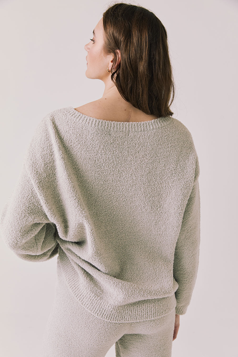 Back view of woman wearing Chaser’s Miller Heather Grey Pullover Sweater on a white background