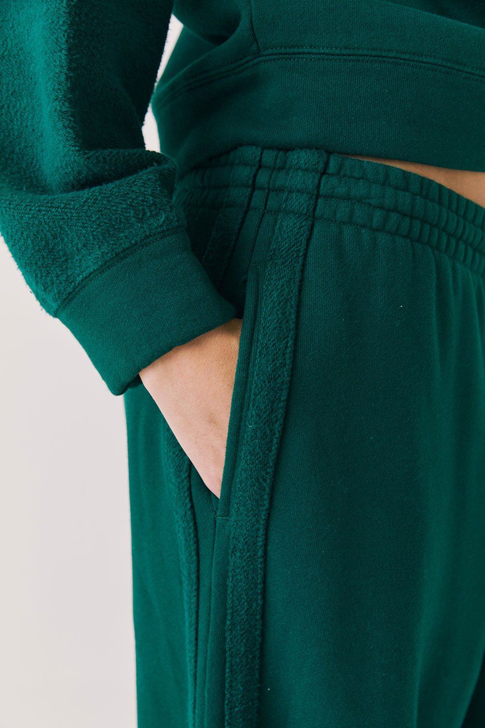 Front view of woman wearing Chaser’s Hazel Joggers in Blue Grass Green on a white background