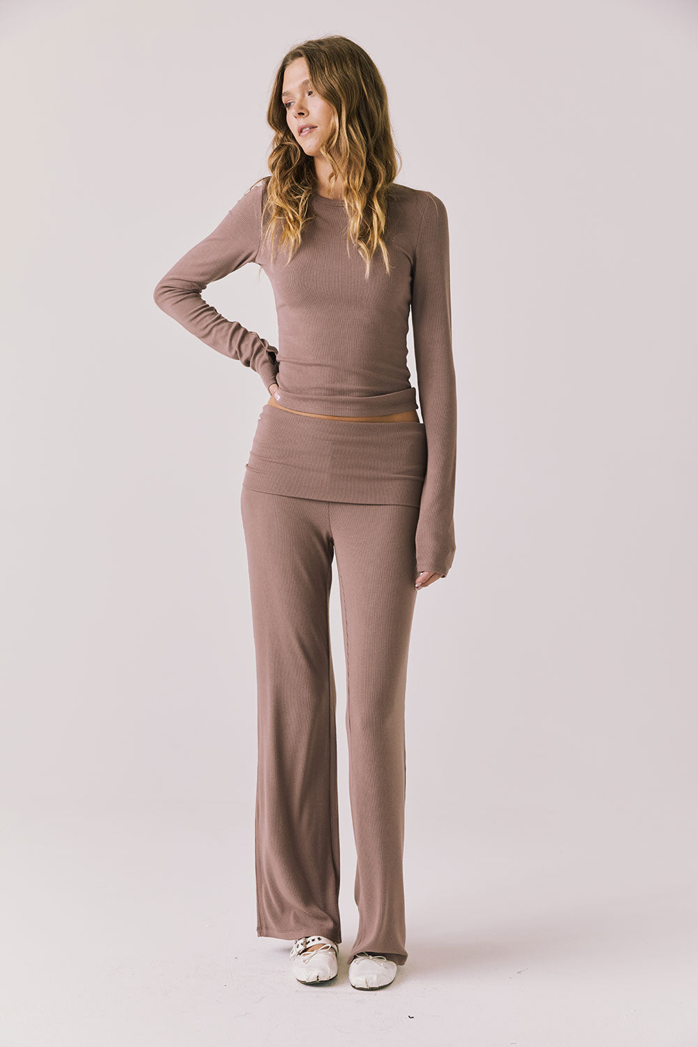 Full body view of woman wearing Chaser’s Porta Deep Taupe Long Sleeve top with matching Mantra Deep Taupe Leggings on a white background