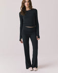 Full body view of woman wearing Chaser’s Porta True Black Long Sleeve top with matching Mantra True Black Legging on a white background