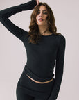 Front view of woman wearing Chaser’s Porta True Black Long Sleeve top on a white background