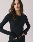 Front view of woman wearing Chaser’s Porta True Black Long Sleeve top on a white background