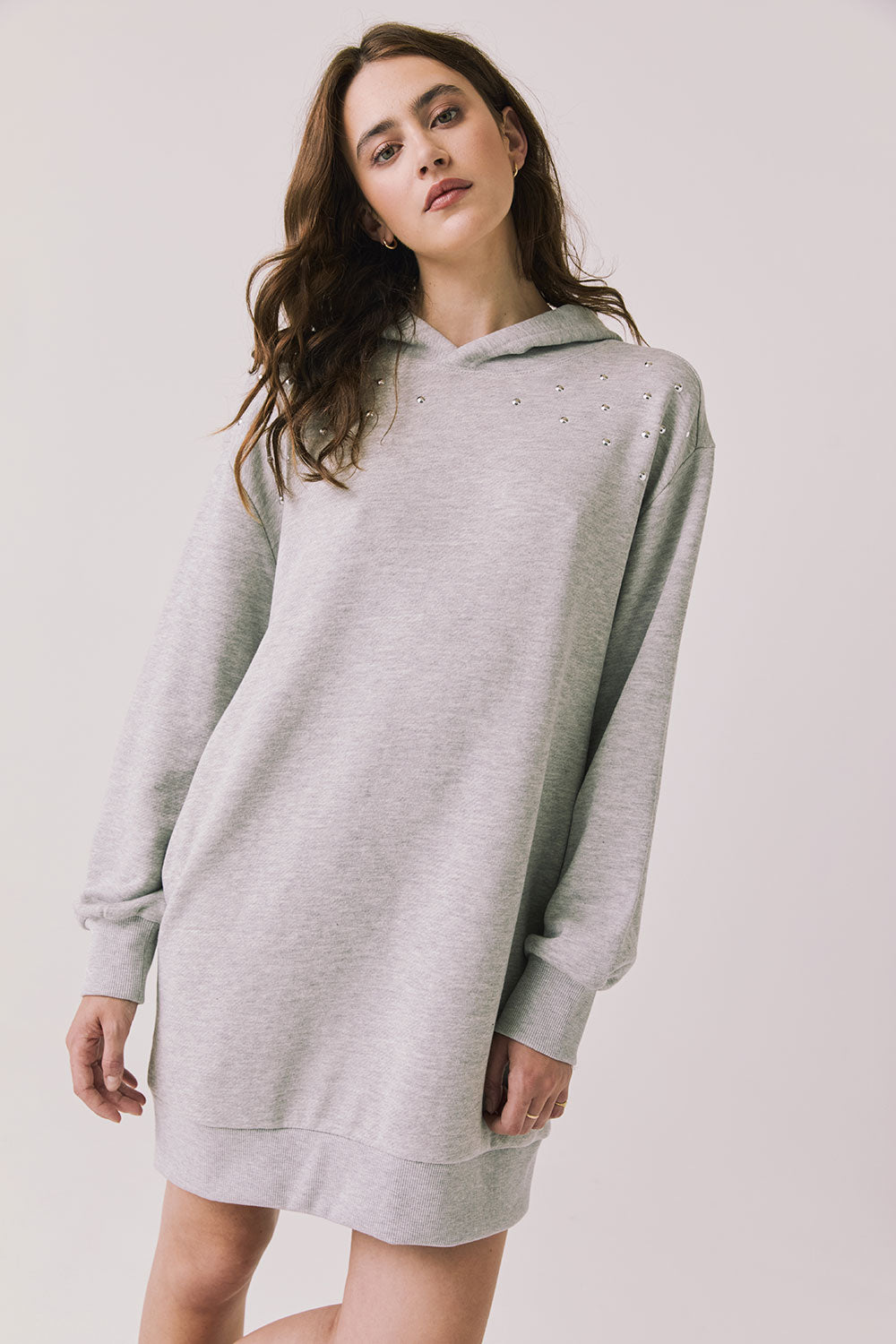 Woman wearing Chaser's Aster Heather Grey Hoodie Dress on a plain background