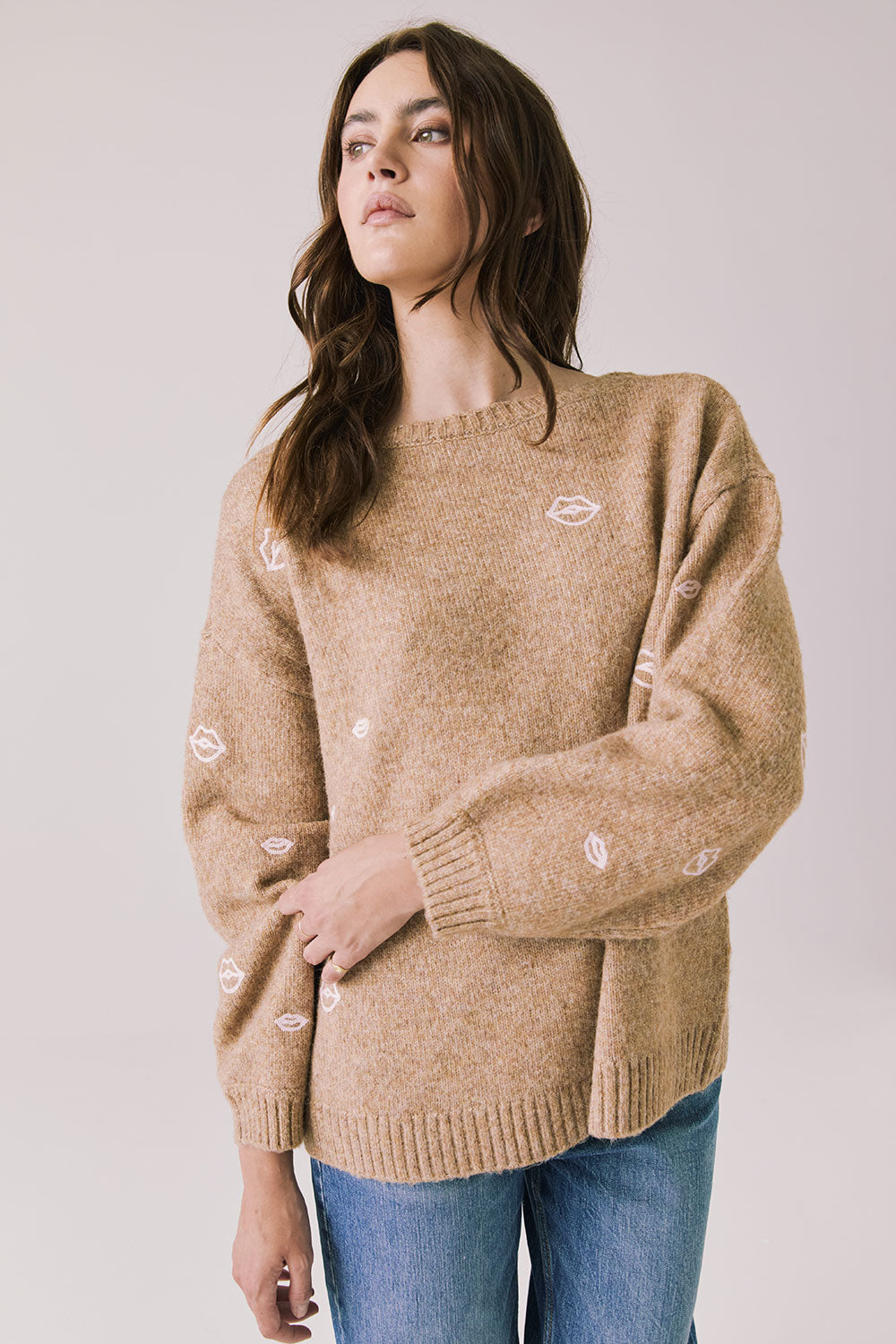 Front view of woman wearing Chaser’s Love Me Long Sleeve Beige Sweater on a plain background