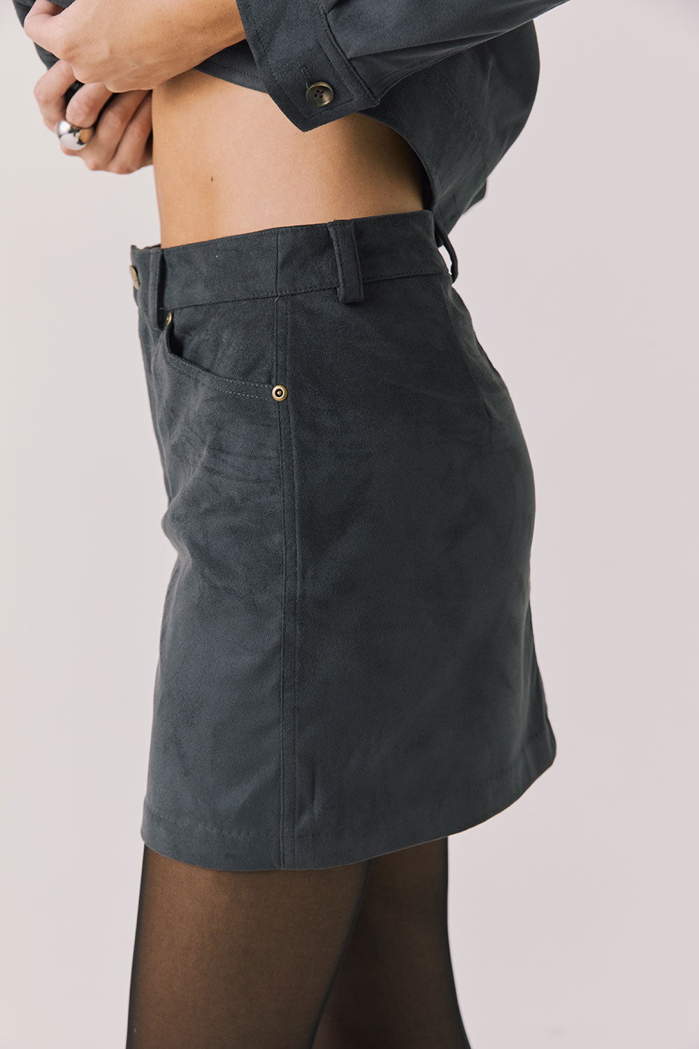 Side view of woman wearing Chaser’s Dusk Jacket on a light background