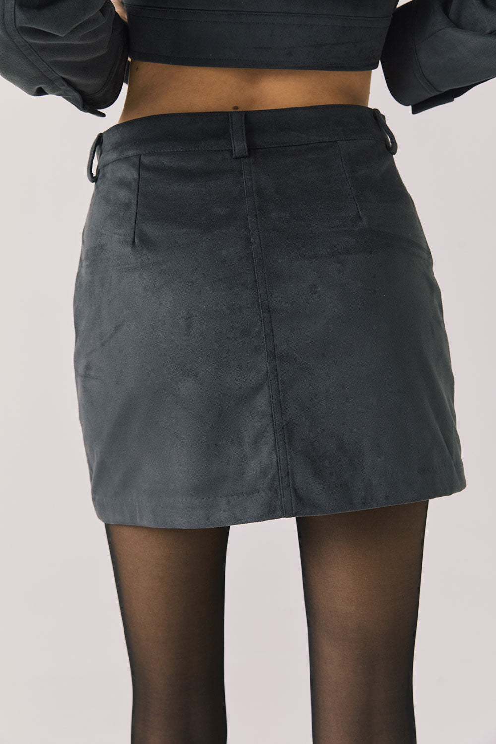 Back view of woman wearing Chaser’s Dusk Jacket on a light background