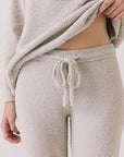 Front view of woman wearing Chaser’s Monica Heather Grey Joggers on a white background