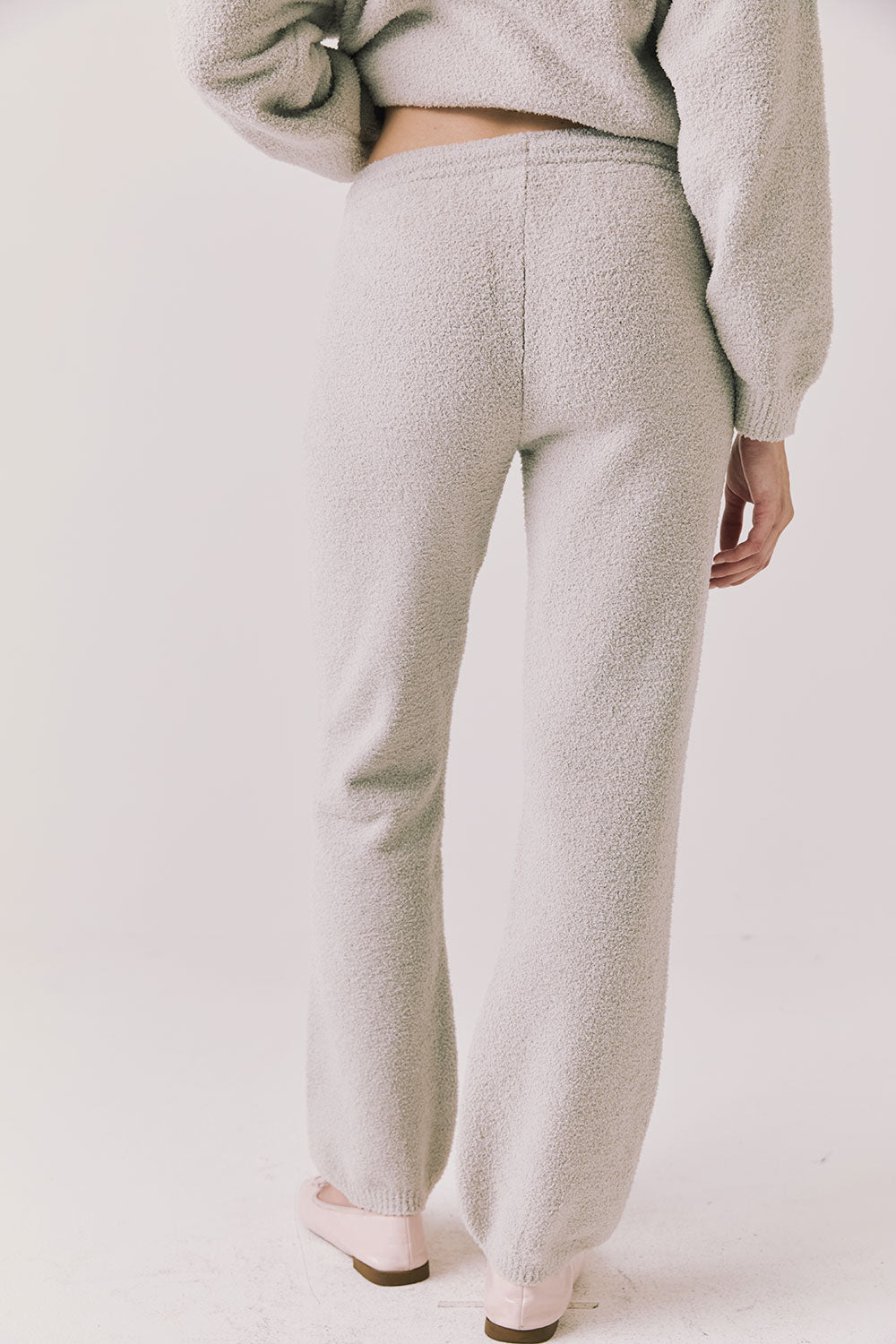 Back view of woman wearing Chaser’s Monica Heather Grey Joggers on a white background