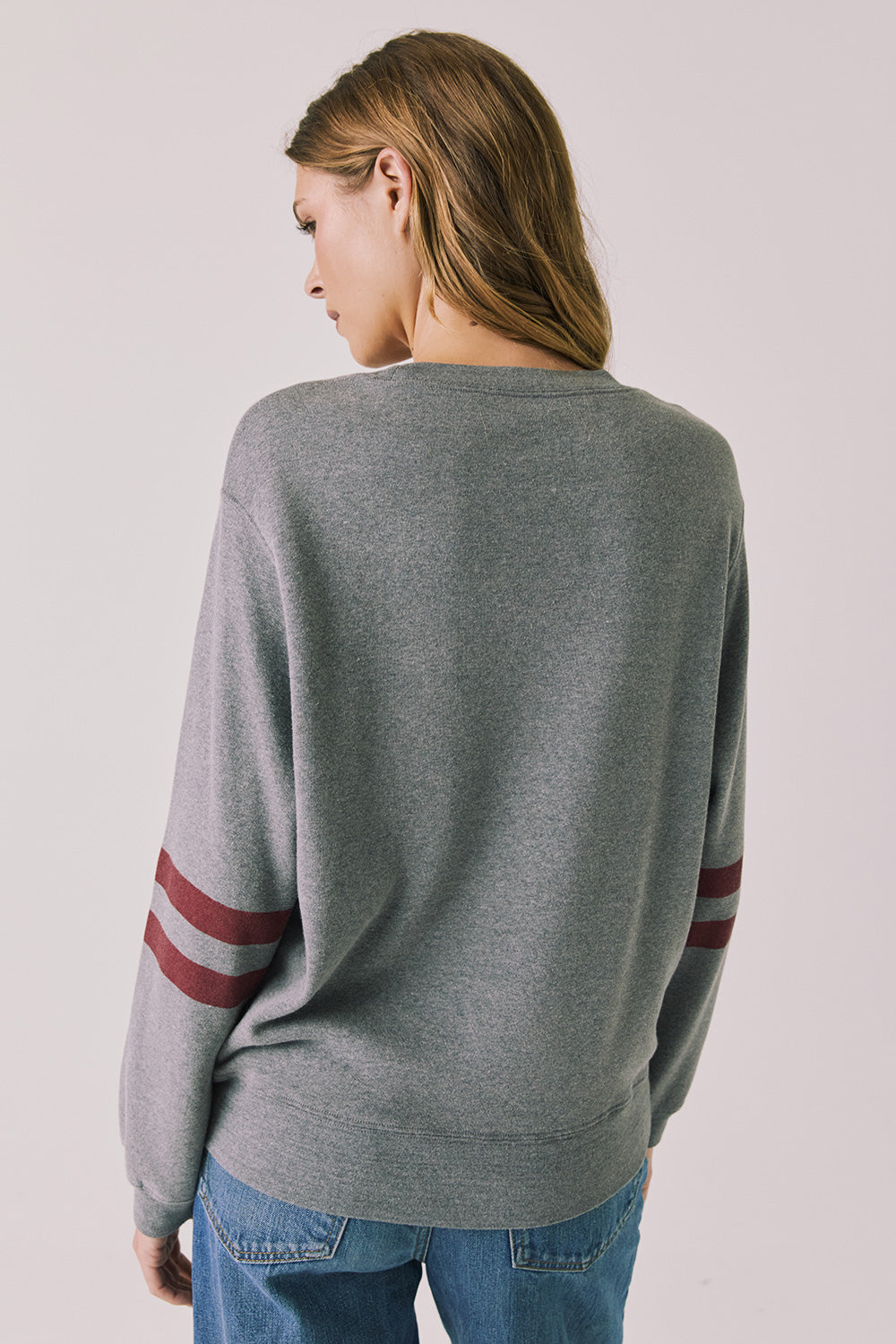 Back view of woman wearing Chaser’s Streaky Grey Merry Long Sleeve against a plain background